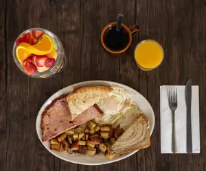 Two Extra Large Eggs, Thick Sliced Ham, Two Eggs served with a Fruit Cup, Orange Juice, and Eggs